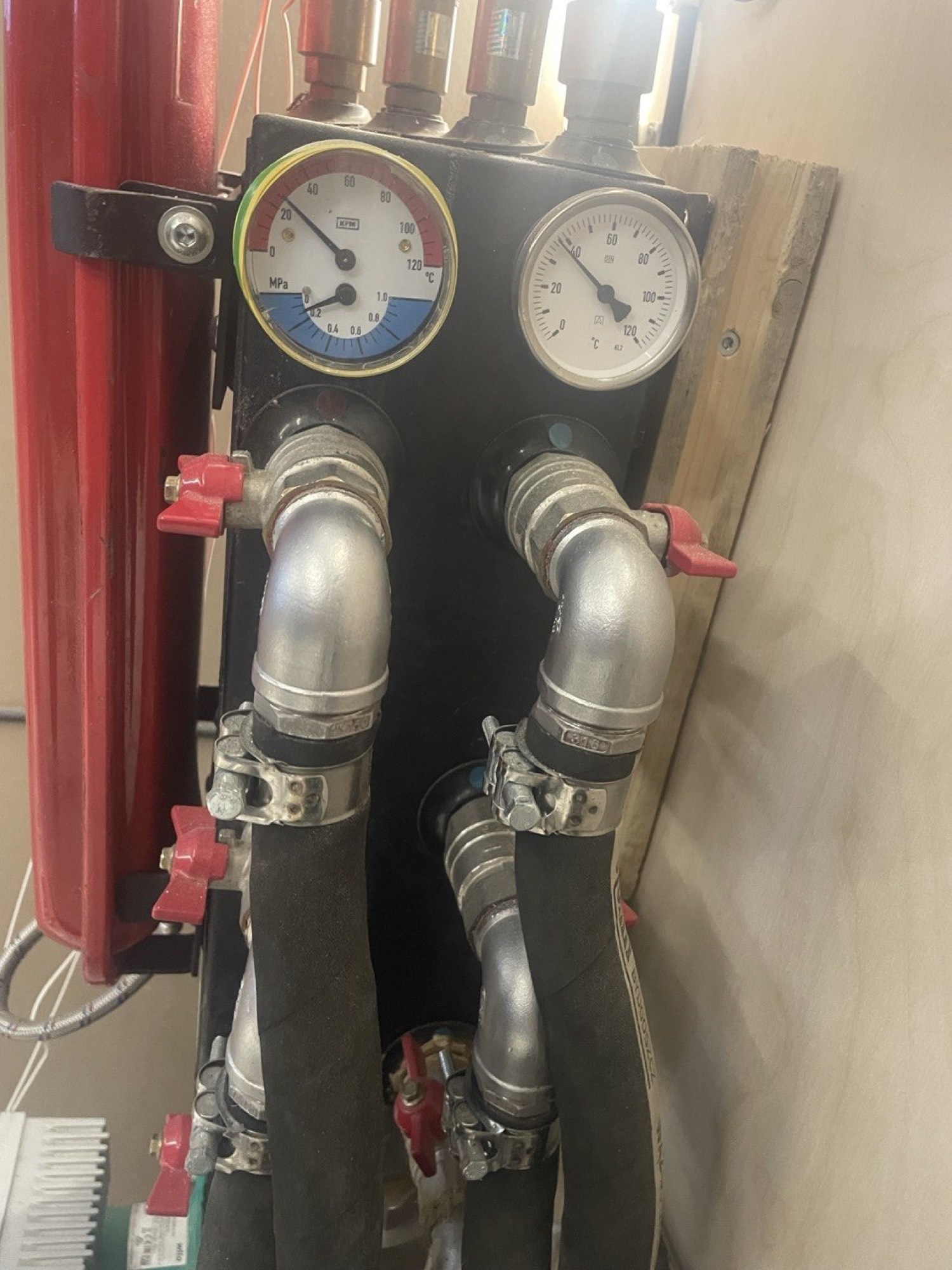 Heat-exchanger manifold with pressure and temperature gauges, taking mining heat off to warm the building